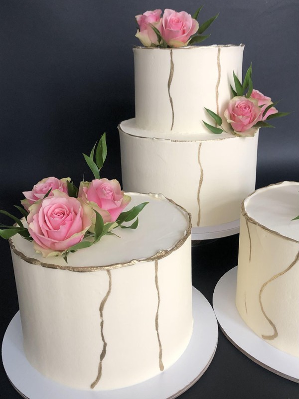 Trio wedding cake with gold and roses